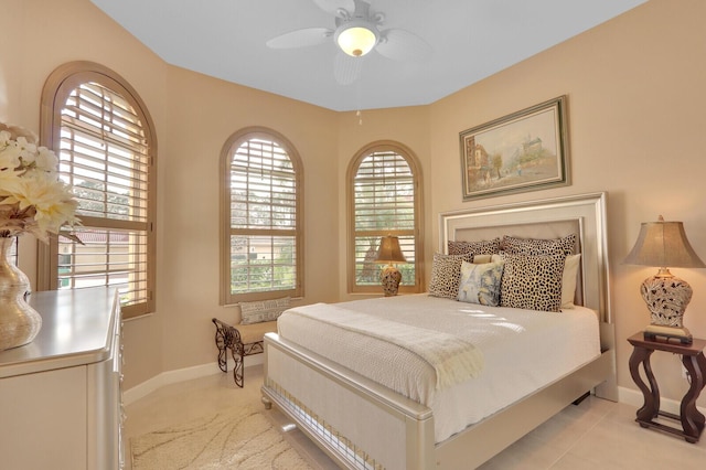 bedroom with ceiling fan and light tile patterned floors