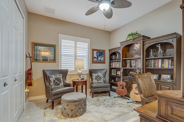 sitting room with light tile patterned floors and ceiling fan