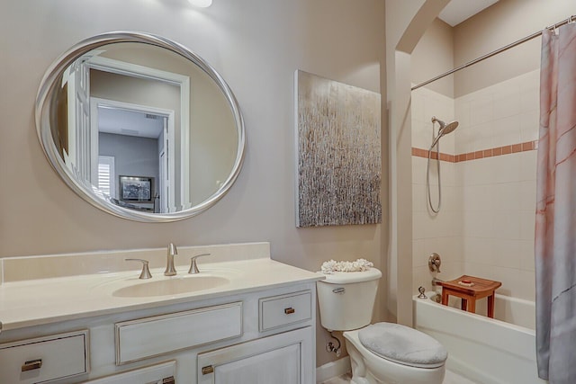 full bathroom featuring shower / tub combo, vanity, and toilet