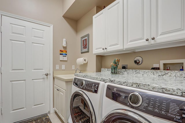 laundry area with washer and clothes dryer, cabinets, and sink