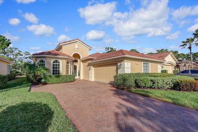 mediterranean / spanish-style house featuring a front lawn and a garage