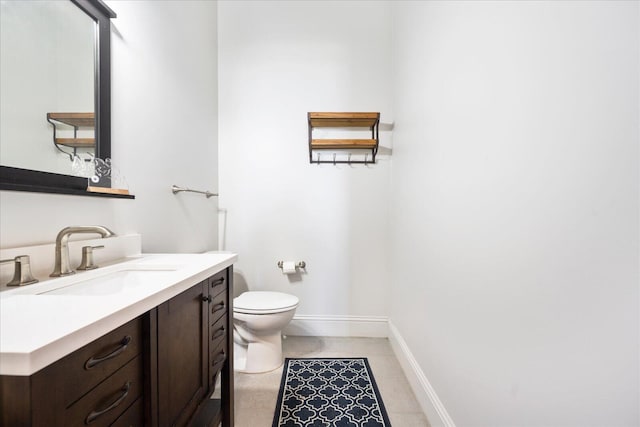 bathroom with tile patterned floors, vanity, and toilet