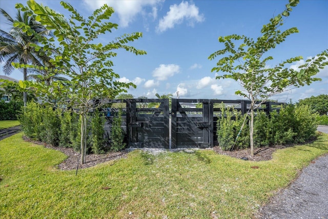 view of gate featuring a yard