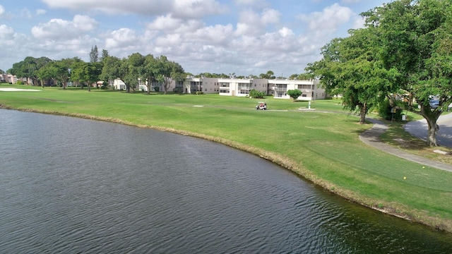 view of community featuring a yard and a water view