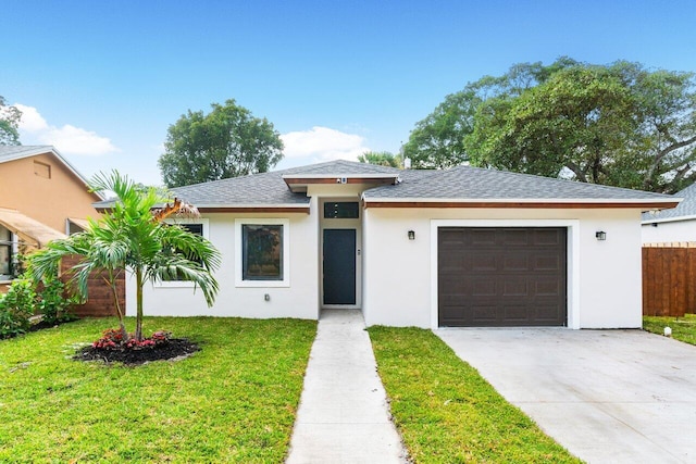 view of front of property featuring a front yard and a garage