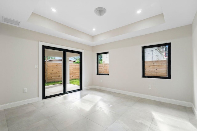 empty room featuring a raised ceiling