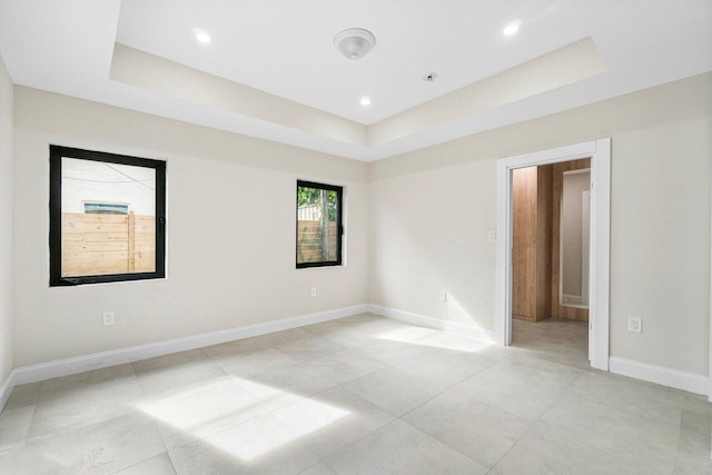 spare room featuring a raised ceiling