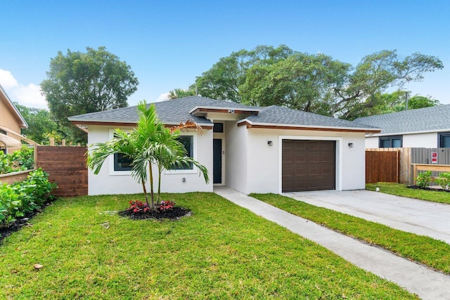 view of front facade with a front yard and a garage