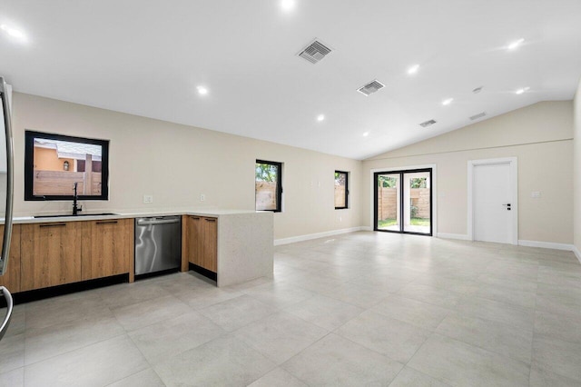 kitchen featuring stainless steel dishwasher, lofted ceiling, and sink