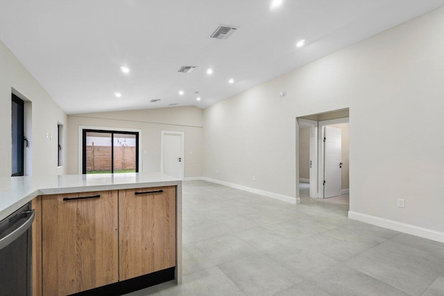 kitchen featuring dishwasher and vaulted ceiling