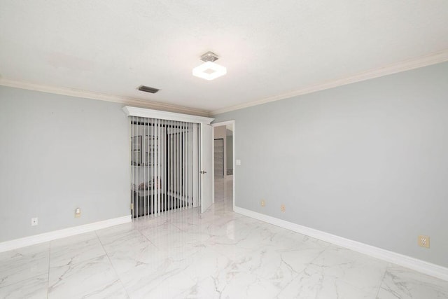 spare room featuring crown molding