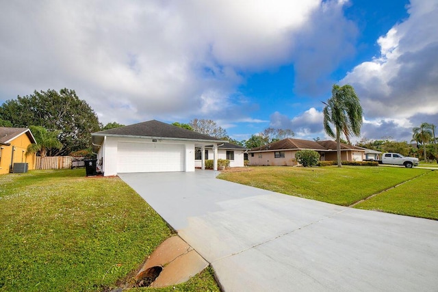 ranch-style home with central AC unit, a garage, and a front yard