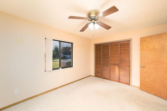 unfurnished bedroom with carpet flooring, a closet, and ceiling fan