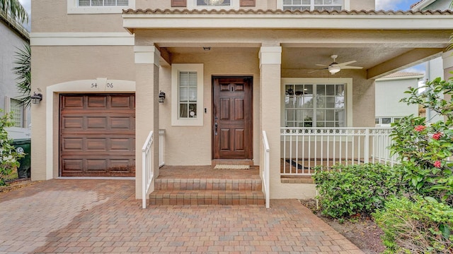 view of exterior entry featuring ceiling fan