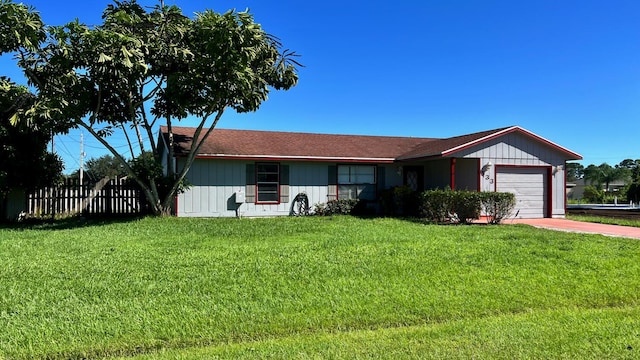 ranch-style house featuring a garage and a front yard