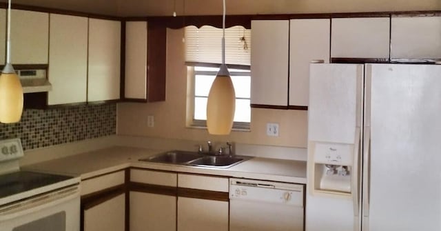 kitchen featuring sink, white appliances, white cabinets, and backsplash