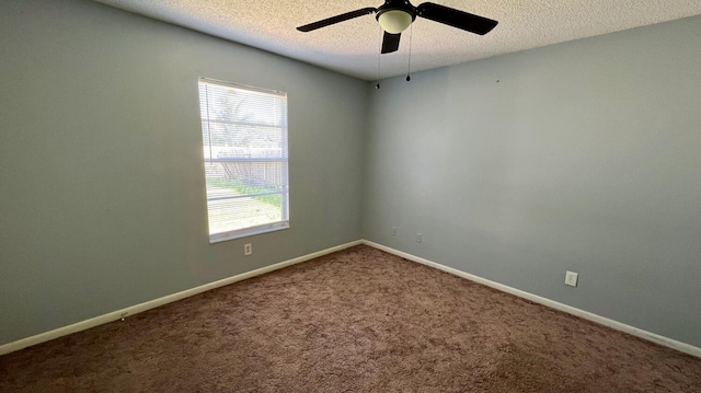 carpeted empty room with ceiling fan and a textured ceiling