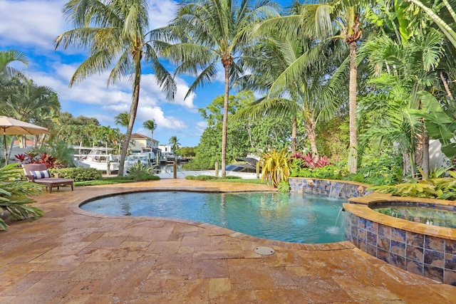 view of swimming pool featuring an in ground hot tub, pool water feature, and a patio