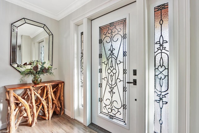 foyer entrance with hardwood / wood-style flooring and ornamental molding