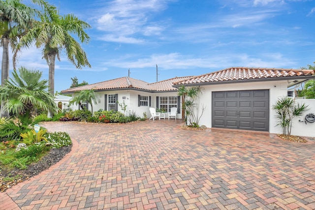 mediterranean / spanish-style home with a garage