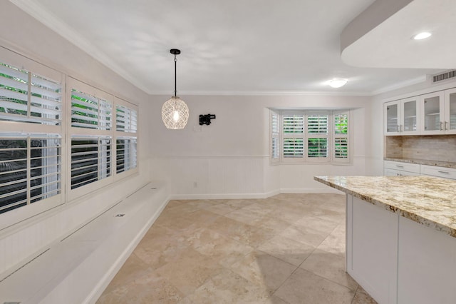 unfurnished dining area with crown molding