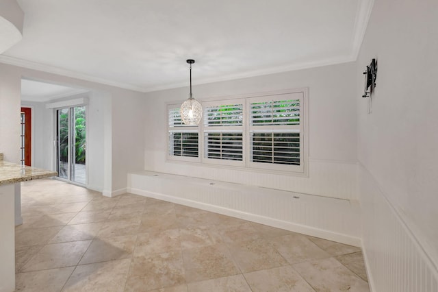 unfurnished dining area with crown molding