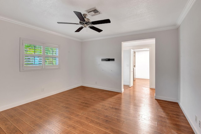 empty room featuring a textured ceiling, ceiling fan, crown molding, and hardwood / wood-style flooring