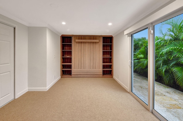 unfurnished room with ornamental molding and light carpet