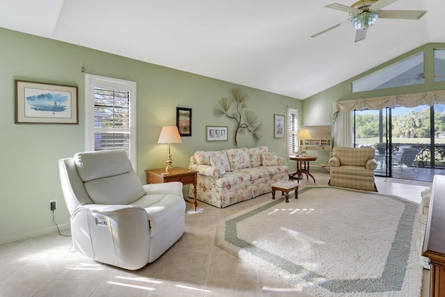 living room featuring ceiling fan, plenty of natural light, light tile patterned floors, and vaulted ceiling