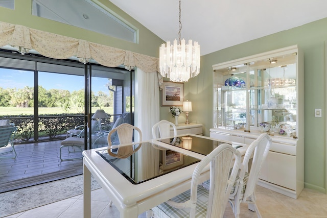 tiled dining space with a wealth of natural light, a chandelier, and lofted ceiling