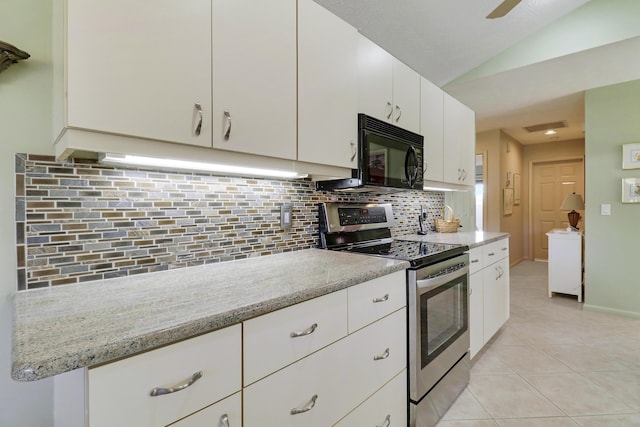 kitchen featuring stainless steel range with electric stovetop, vaulted ceiling, white cabinets, and tasteful backsplash