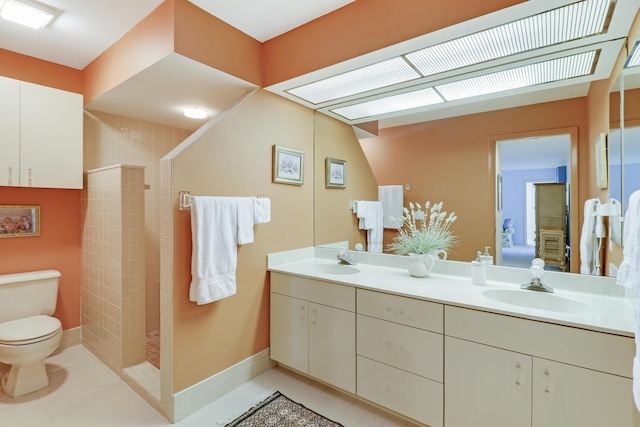 bathroom with toilet, tile patterned flooring, vanity, and tiled shower