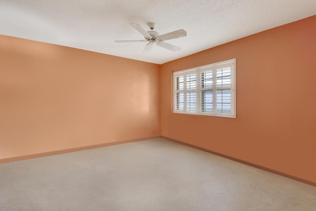 unfurnished room featuring ceiling fan, carpet, and a textured ceiling