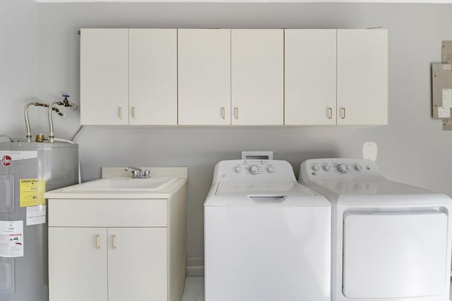 laundry room with cabinets, electric water heater, washer and clothes dryer, and sink