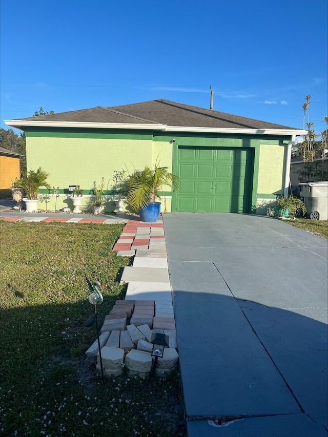 exterior space with a yard and a garage