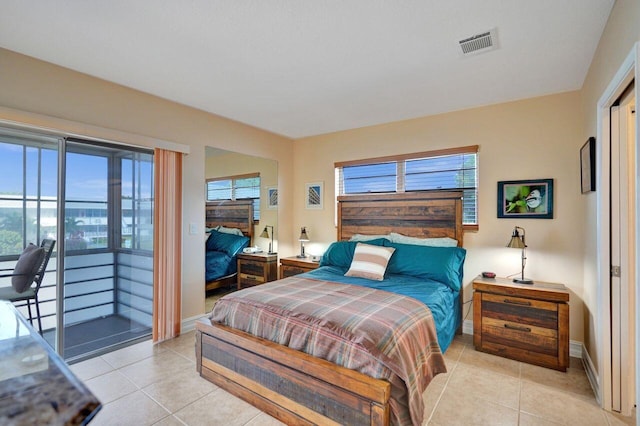 bedroom with light tile patterned floors and access to outside