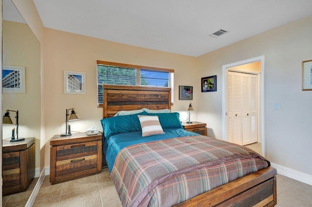 bedroom featuring light tile patterned flooring and a closet