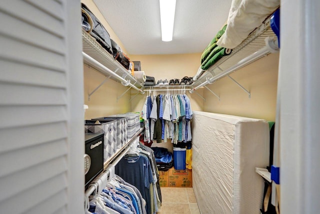 walk in closet featuring light tile patterned flooring