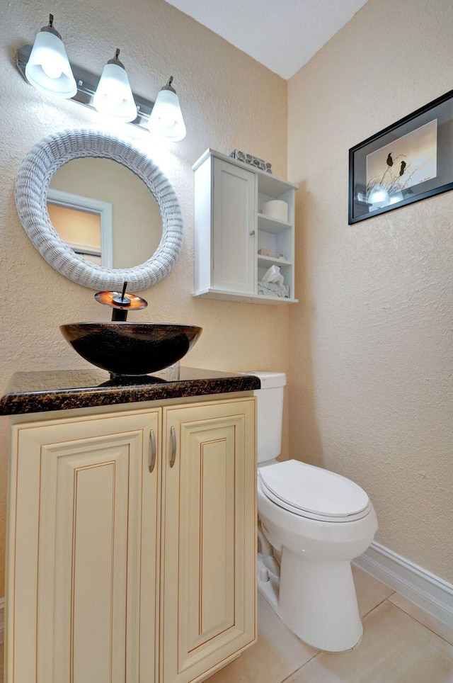 bathroom with tile patterned floors, vanity, and toilet