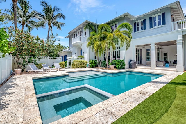 view of swimming pool featuring a patio, ceiling fan, and an in ground hot tub