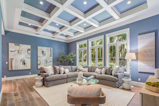 living room with a high ceiling, coffered ceiling, wood-type flooring, ornamental molding, and beamed ceiling