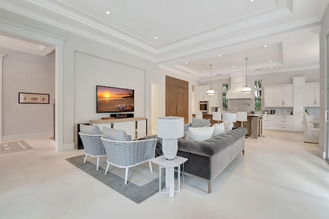 living room featuring a raised ceiling and crown molding