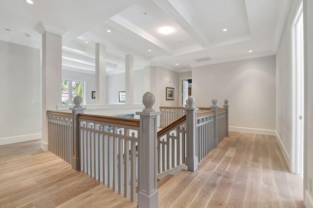 hall with beam ceiling, light wood-type flooring, and ornamental molding