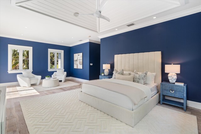 bedroom with light wood-type flooring, multiple windows, crown molding, and ceiling fan