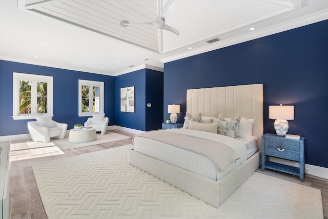 bedroom with ornamental molding, ceiling fan, and light hardwood / wood-style floors