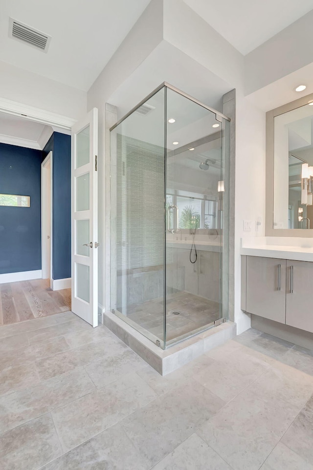 bathroom with vanity, hardwood / wood-style flooring, and walk in shower