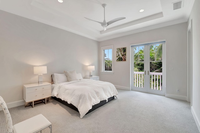 bedroom featuring ceiling fan, french doors, a raised ceiling, access to outside, and light carpet