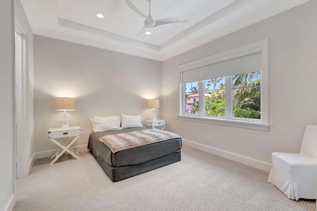 bedroom featuring carpet flooring, a raised ceiling, ceiling fan, and crown molding