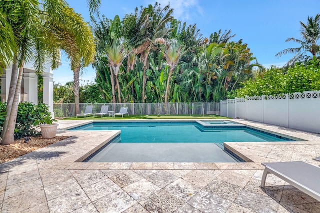 view of pool with an in ground hot tub