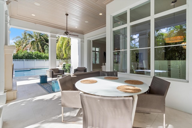 sunroom with ceiling fan and wooden ceiling